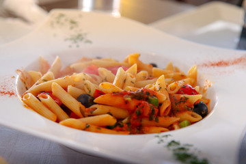 Pasta with spicy tomato sauce, parmesan and basil. Pasta Chifferi Rigati