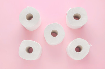white toilet paper rolls on pink background