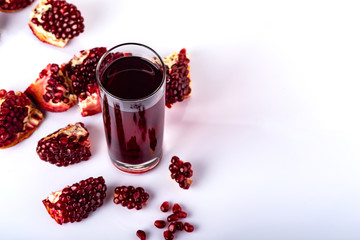 Ripe pomegranate fruit with leaves on white background.