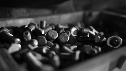 Close up of steel nuts and bolts in tool box - obrazy, fototapety, plakaty