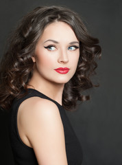 Attractive woman portrait. Perfect model with makeup and curly hair