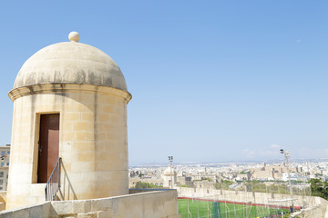 Hastings Gardens watch tower and football field over the city of Valletta, Malta