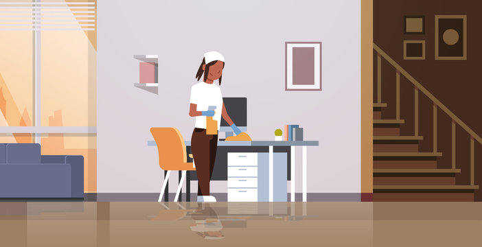 housewife cleaning computer table with duster african american woman wiping workplace desk housework concept modern living room interior female cartoon character full length horizontal