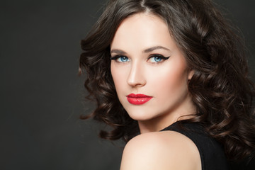 Fototapeta premium Beautiful woman with makeup and dark curly hair portrait