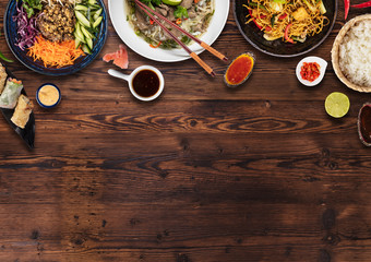 Top view composition of various Asian food in bowls