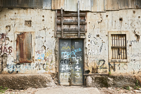 Close-up view of the front of an abandoned ruined building, windows and door closed, Puerto Princesa City, Palawan, Philippines