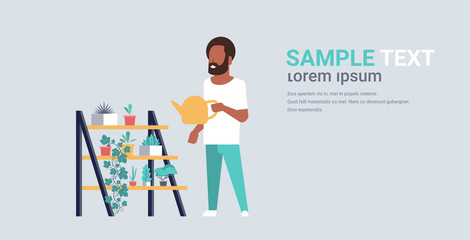 man watering potted plants on rack african american guy holding sprinkling can doing housework concept male cartoon character full length horizontal copy space