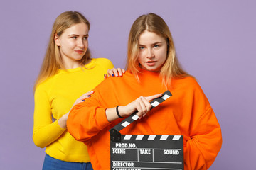 Two beautiful young blonde twins sisters girls in colorful cloth