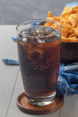 close up of iced cola in glass on the table