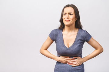 Young beautiful woman having abdominal pain isolated on white background.