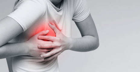 Young woman feel menstrual cyclic breast pain touching her chest