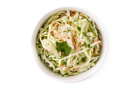 Coleslaw salad in white bowl isolated on white background. Top view