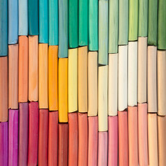 Multicolored rainbow pastel crayons in rows as background. Square image