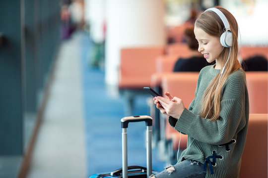 Adorable Little Girl At Airport In Big International Airport Near Window