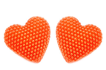 A pair of red hearts isolated on a white background.