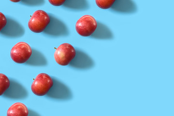 Juicy ripe red apples on a blue pastel background. Minimal concept.