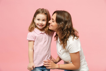 Woman in light clothes have fun with cute child baby girl. Mother, little kid daughter isolated on pastel pink wall background, studio portrait. Mother's Day, love family, parenthood childhood concept