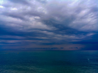 sea landscape is a pebbly beach with waves in white foam