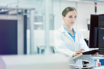 Engineer operating manufacturing line in electronics factory