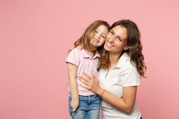 Woman in light clothes have fun with cute child baby girl. Mother, little kid daughter isolated on...