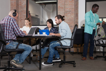 Young adults focused on work in office