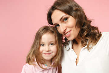 Close up selfie shot woman in light clothes have fun with cute child baby girl. Mother, little kid daughter isolated on pastel pink wall background, studio portrait. Mother's Day, love family concept.