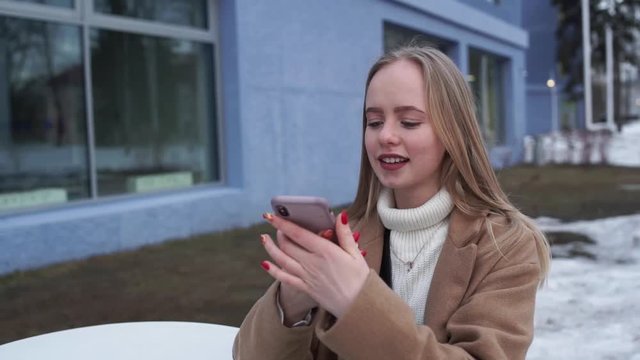 girl using smart phone voice recognition, dictates thoughts, chat, student model young
