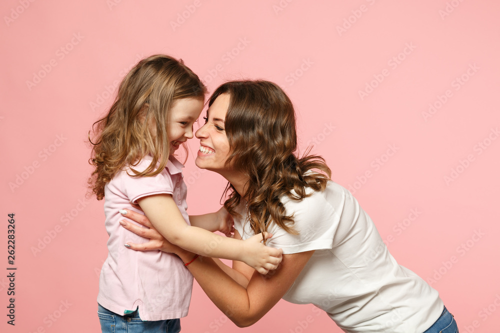 Wall mural woman in light clothes have fun with cute child baby girl. mother, little kid daughter isolated on p