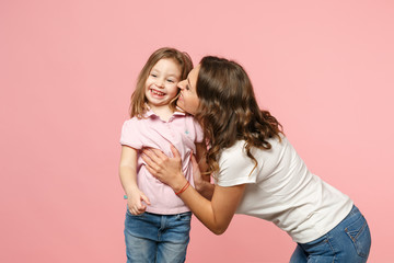 Woman in light clothes have fun with cute child baby girl. Mother, little kid daughter isolated on pastel pink wall background, studio portrait. Mother's Day, love family, parenthood childhood concept