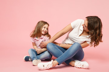 Woman in light clothes have fun with cute child baby girl. Mother, little kid daughter isolated on...