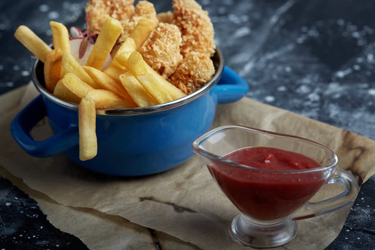 Lunch Or Snack - Fried Chicken Strips And French Fries In A Metal Pan With Tomato Sauce. Craft Paper On The Background.