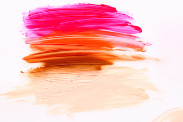 Multicolored lipstic smudge white isolated background.Red brown orange lipstic smudge.