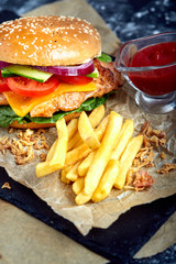 Delicious burgers with beef, tomato, cheese and french fries with tomato sauce
