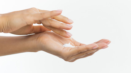 Skin care. Woman applying moisturizing cream to her hands