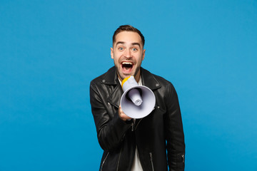 Handsome young unshaven man in black jacket white t-shirt scream in megaphone, announces discounts...