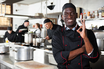 African american professional chef male in kitchen of restaurat
