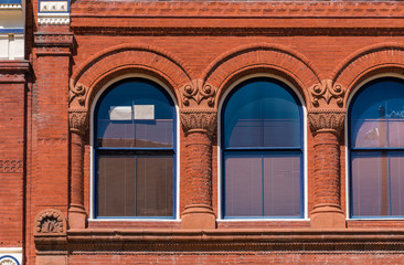 Architectural detail of arch window, red brick facade, vintage old style