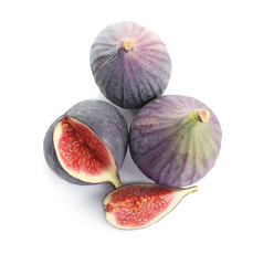 Whole and cut purple figs on white background, top view