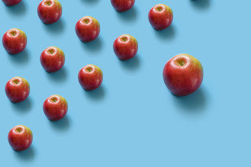 Juicy ripe red apples on a blue pastel background. Minimal concept.