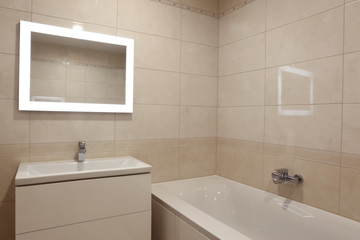 Interior of modern bathroom with beautiful mirror