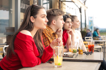 Group of friends drinking something in a bar