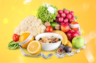 Diet weight loss breakfast concept with tape measure, fruit and cereal