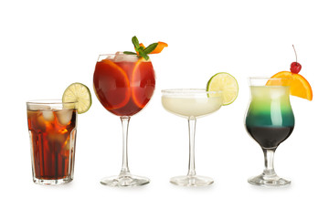 Glasses of traditional alcoholic cocktails on white background