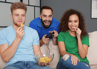 Emotional friends playing video games at home