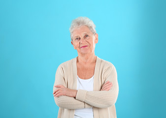 Portrait of grandmother in stylish clothes on color background