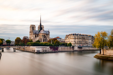 View at the Cathedral Notre Dame on the ice de la cite, with the river Seine in foreground. Longtime Exposure