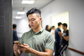 Asian handsome men concentrating on smartphone | typing message on cellphone