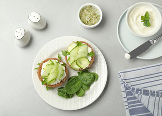 Flat lay composition with traditional English cucumber sandwiches on grey background