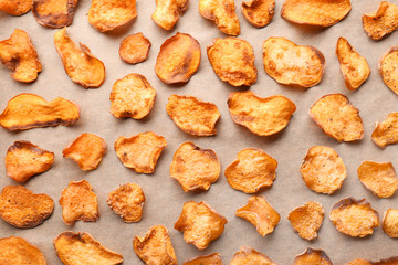 Sweet potato chips on parchment, flat lay