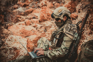 Soldiers of special forces on wars at the desert,Thailand people,Army soldier use laptop for see...